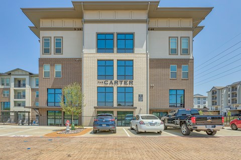 The Carter building has a parking lot in front of it.