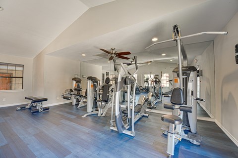 A spacious home gym with a variety of exercise equipment.
