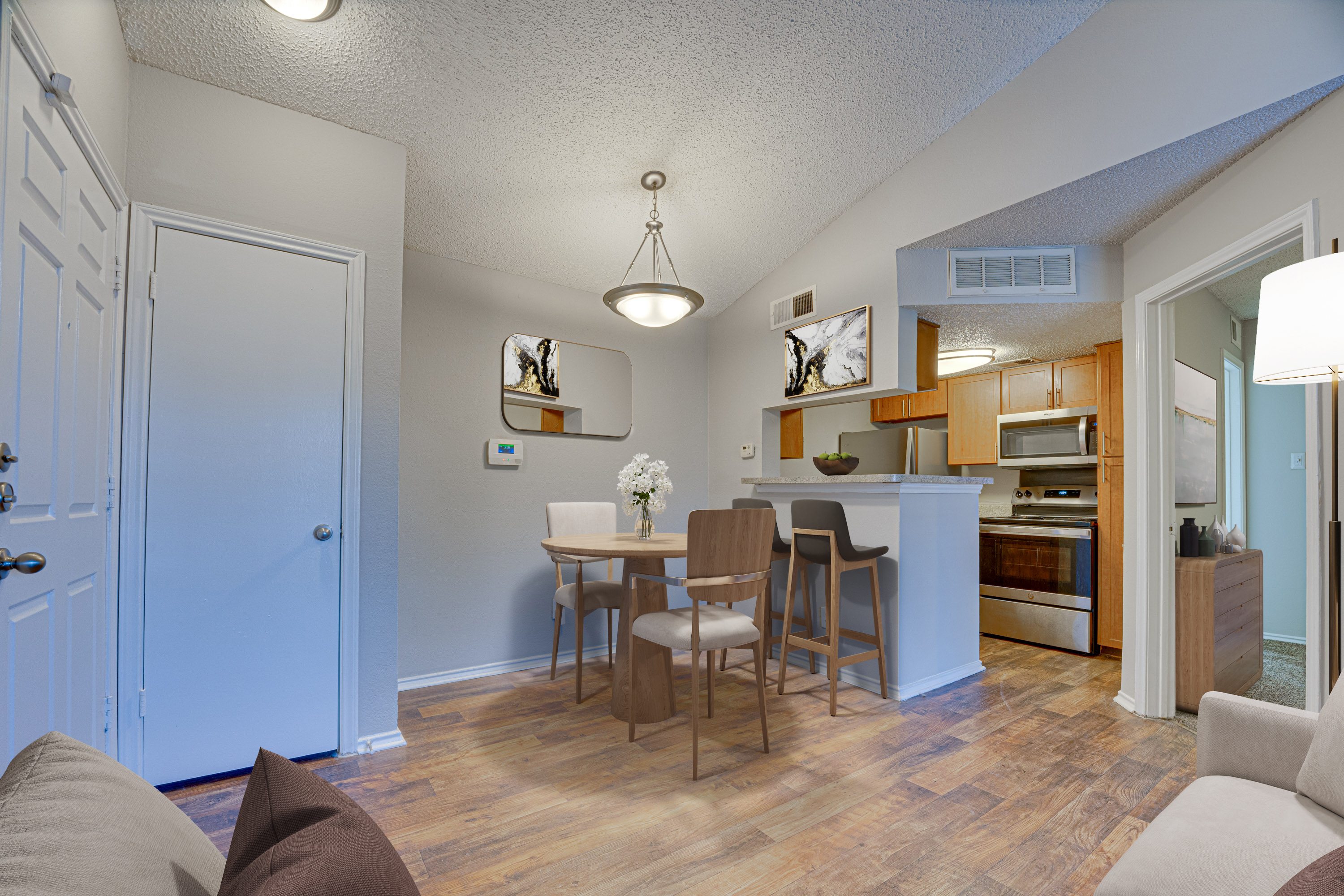 A kitchen with a dining table and chairs.
