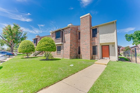 A house with a red door and a brick chimney.