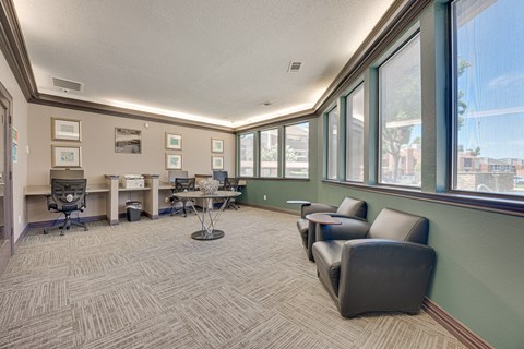 A conference room with a table, chairs and pictures on the wall.