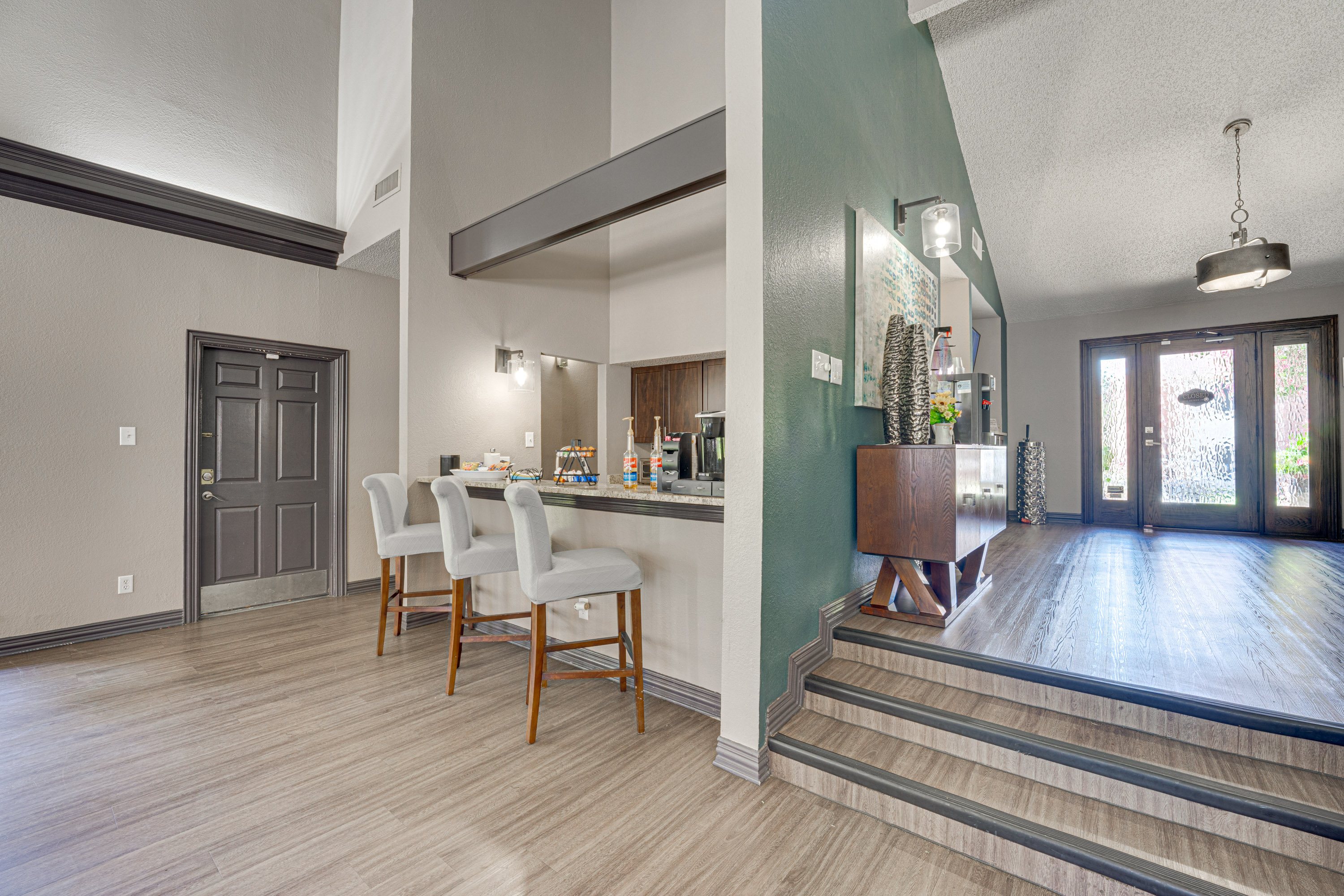 A kitchen with a dining table and chairs.