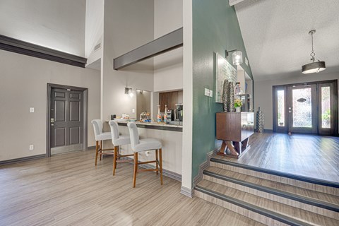 A kitchen with a dining table and chairs.