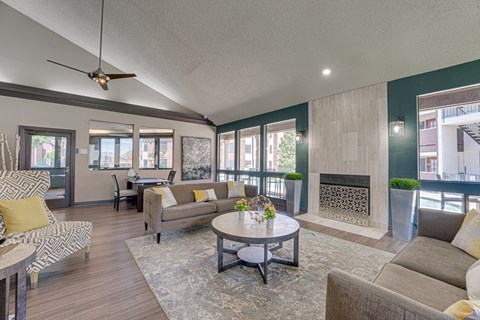A living room with a fireplace and a ceiling fan.