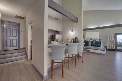 A dining room with a table and chairs.