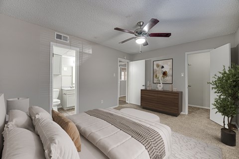 A bedroom with a bed, dresser, and mirror.