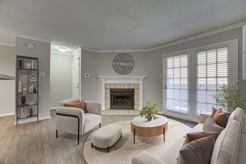 A living room with a fireplace and a clock on the wall.