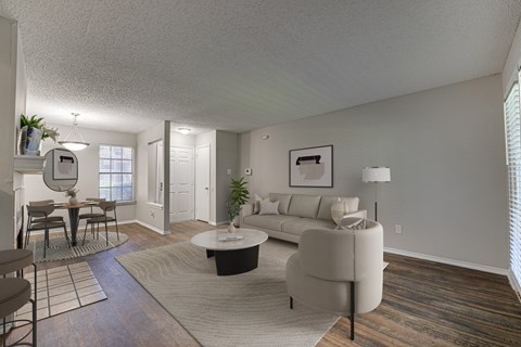 A living room with a couch, chairs, and a coffee table.