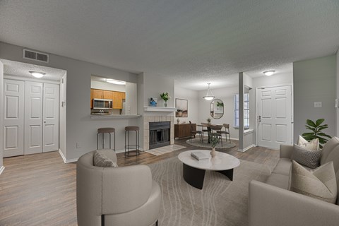 A living room with a fireplace and a dining area.