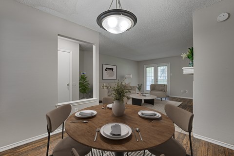 A dining room with a table set for two.