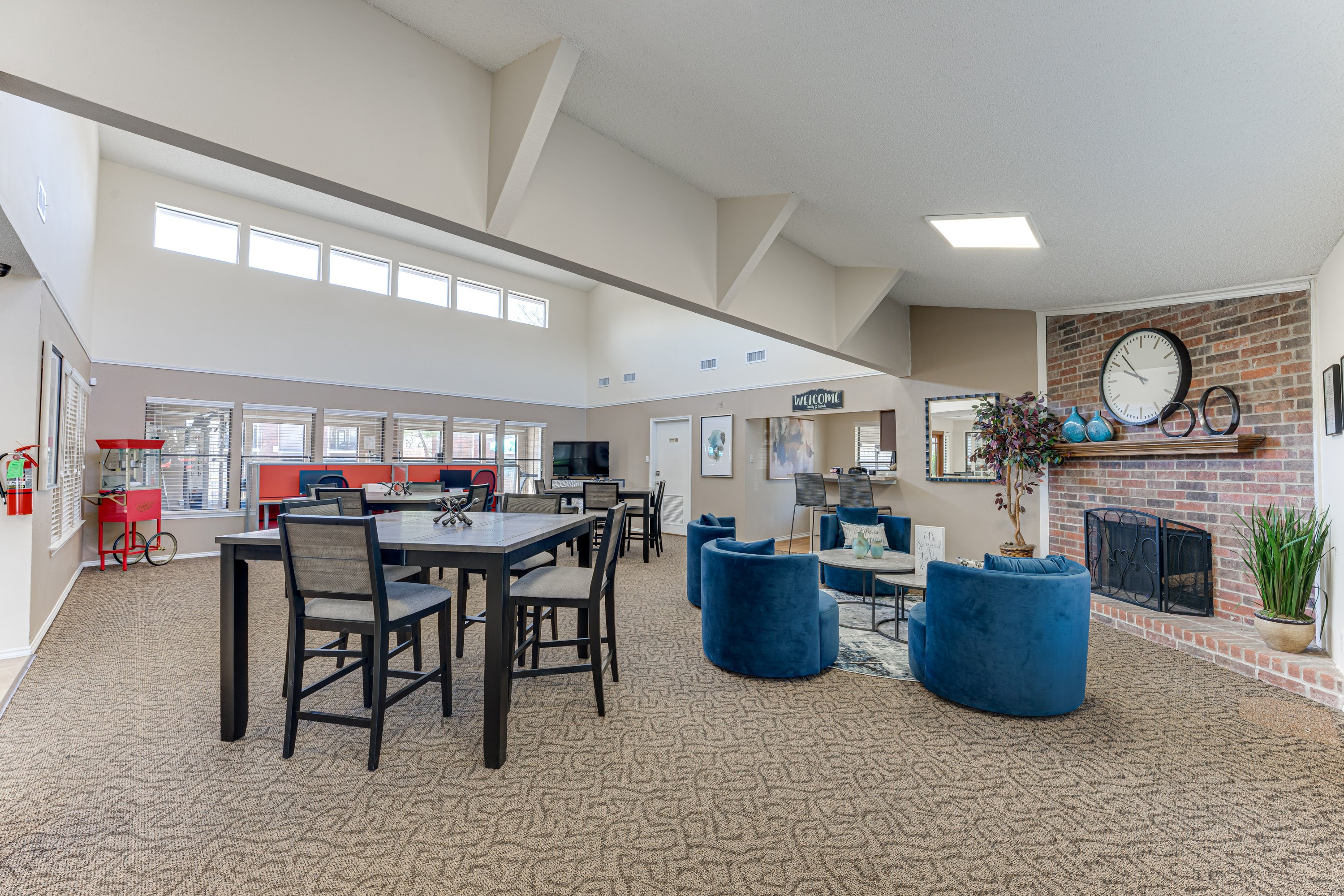 A large open living room with a dining table and chairs.