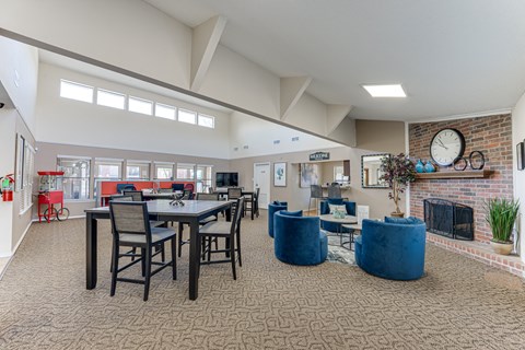 A large open living room with a dining table and chairs.