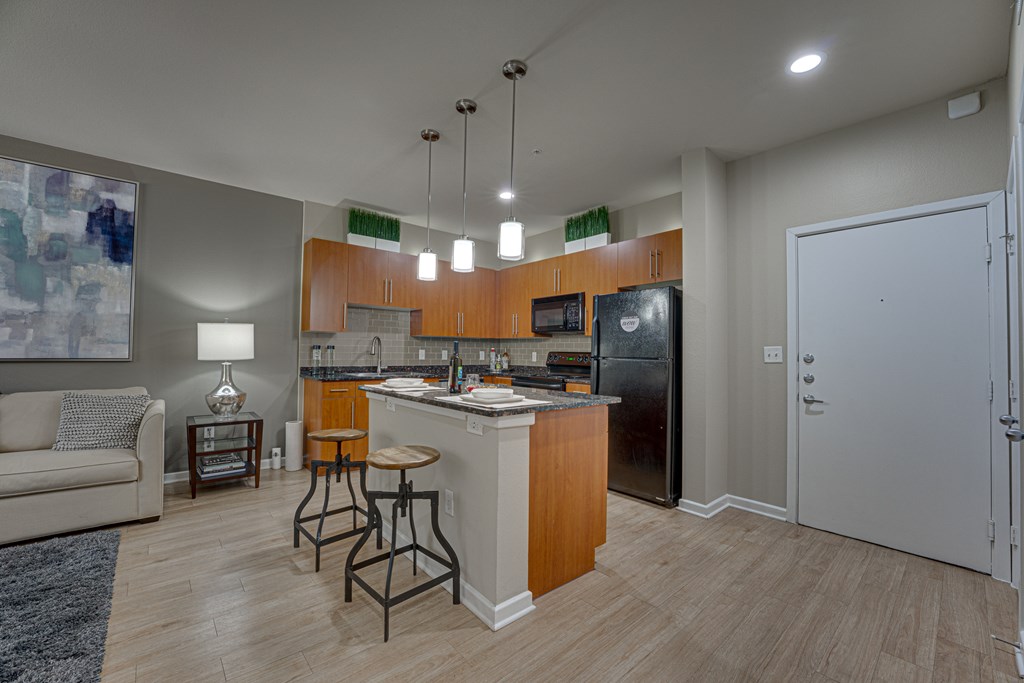 A kitchen with a refrigerator, microwave, and oven. at Vue Greenville, Texas