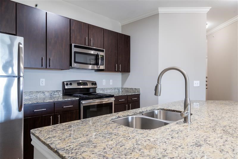 A kitchen with granite countertops and stainless steel appliances.