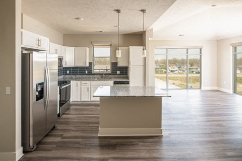 a large kitchen with stainless steel appliances and a counter top