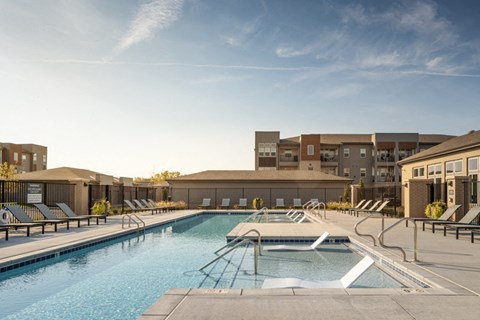 A large outdoor swimming pool with steps leading into the water.
