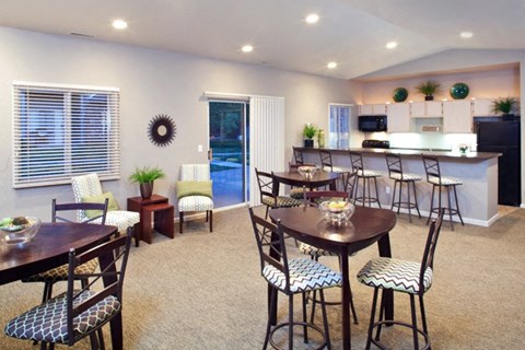 A dining room with a table set for six.