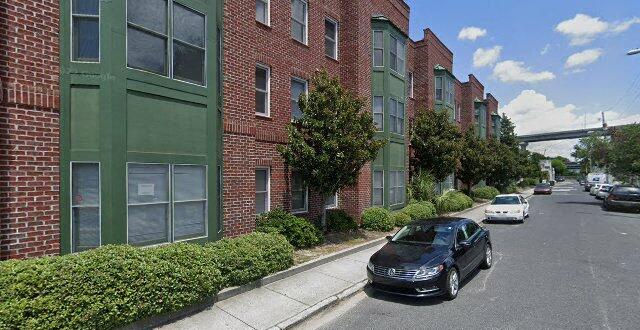 a car parked on the street in front of a brick building