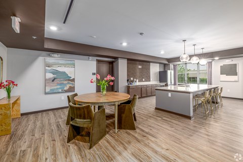 A dining room with a wooden table and chairs.