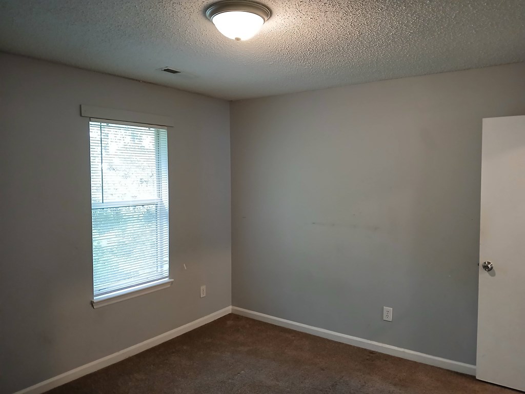 A room with a window and a door.