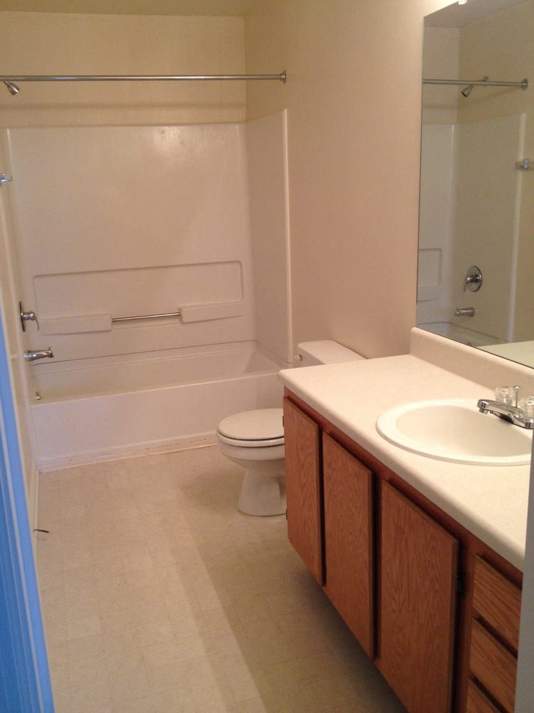 a bathroom with a sink toilet and a bath tub
