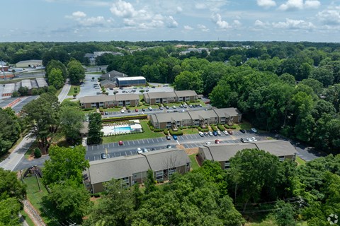 A large building complex surrounded by trees.
