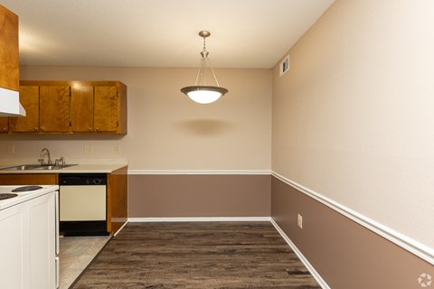 A kitchen with a white dishwasher and a white oven.