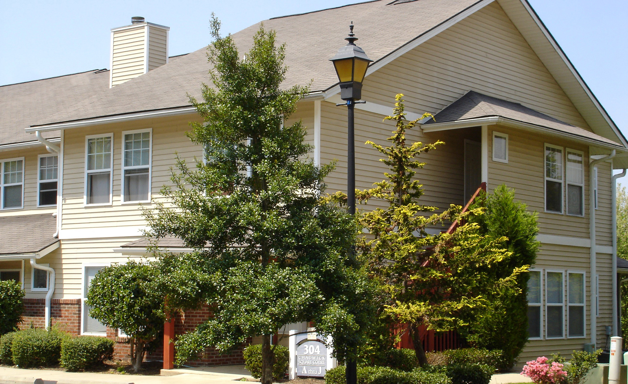 A house with a tree in front of it.