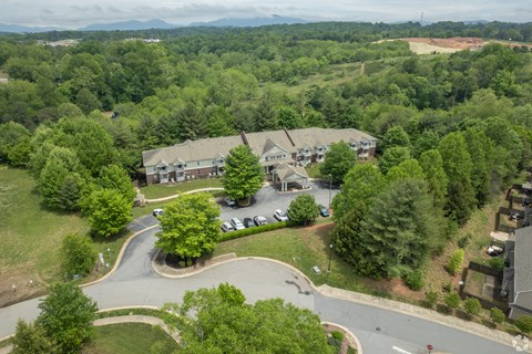 A bird's eye view of a residential area with houses and trees.