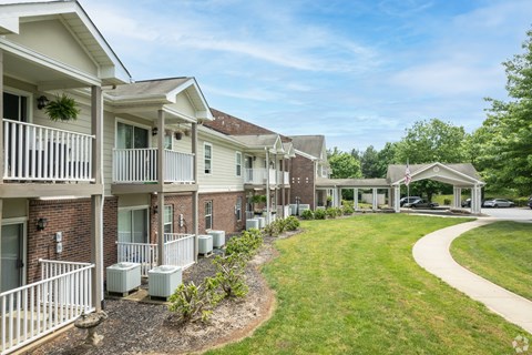 A row of apartment buildings with a flag on the roof of the last one.