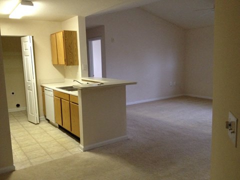 an empty kitchen and living room in an empty house