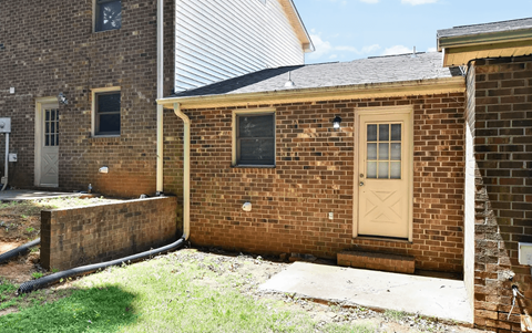 A brick house with a door and windows.