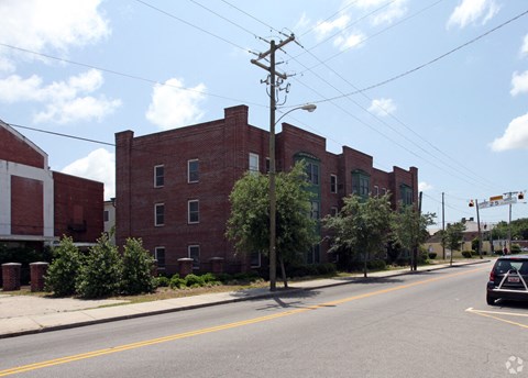 a red brick building on the corner of a city street