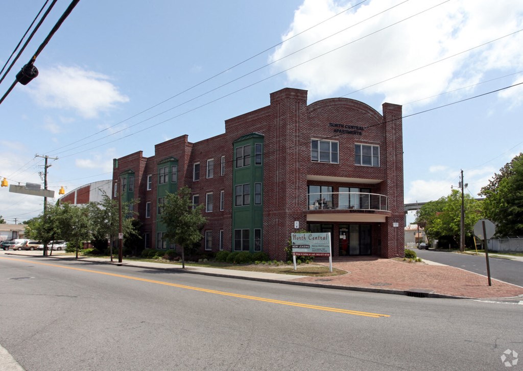 a red brick building on the corner of a street