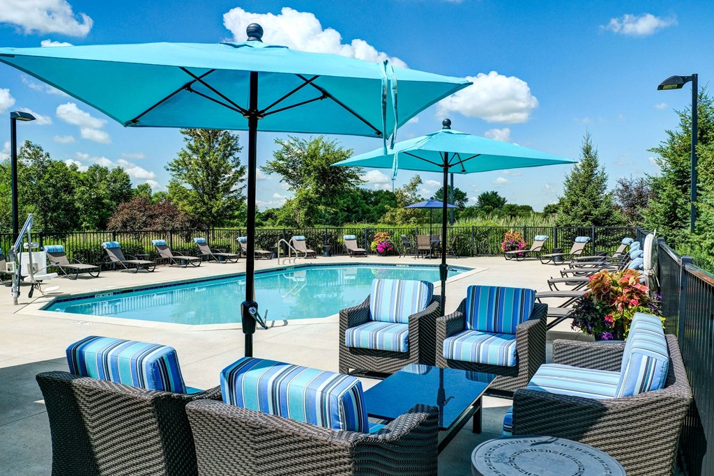 outdoor seating area next to a swimming pool
