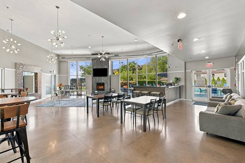 A spacious living room with a fireplace and a dining table.