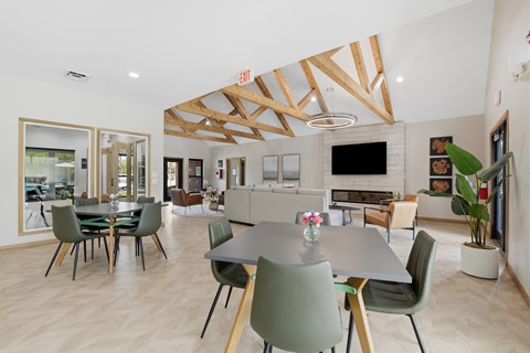 A modern dining room with a large table and chairs.