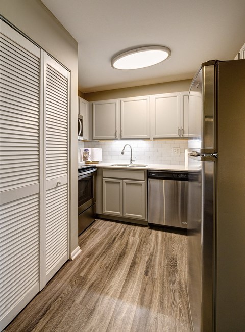 a kitchen with stainless steel appliances and white cabinets