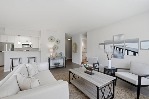 A modern living room with a white couch and a coffee table.