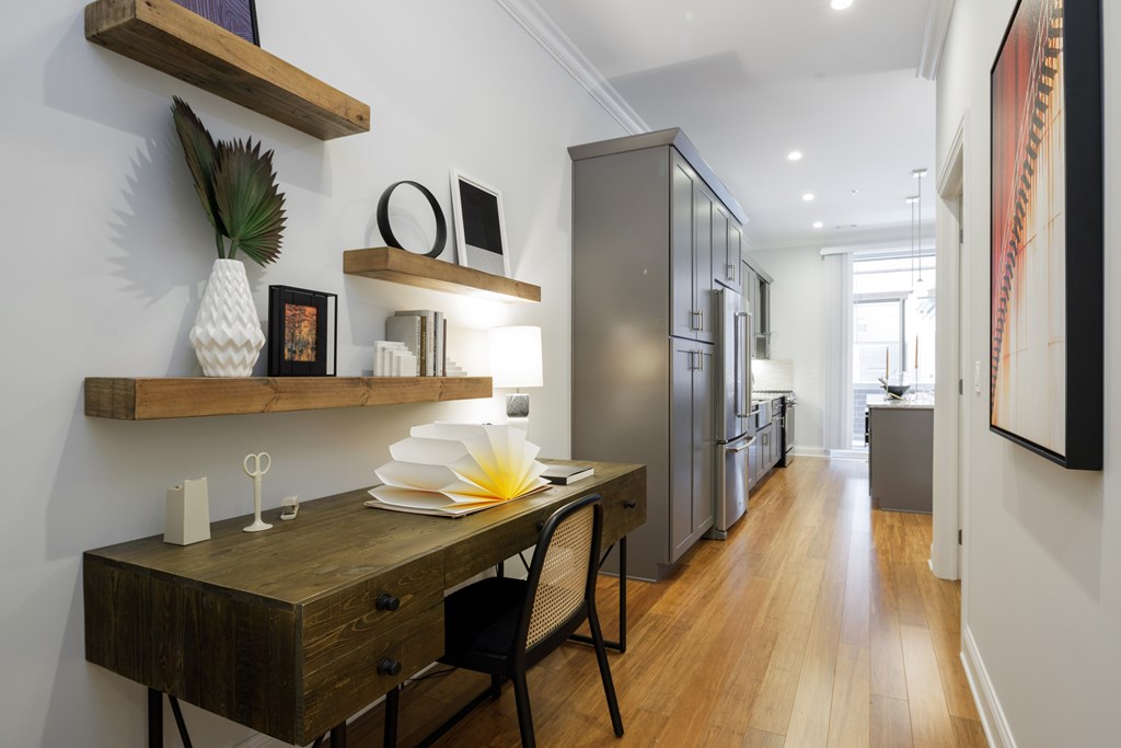A modern kitchen with a wooden table and chairs.