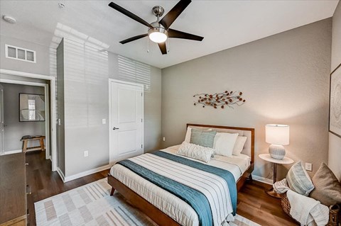 a bedroom with a bed and a ceiling fan