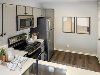 a kitchen with stainless steel appliances and a stainless steel sink