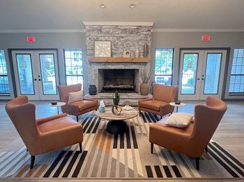 sitting area in front of a fireplace in the clubhouse at The Addison at Southfield