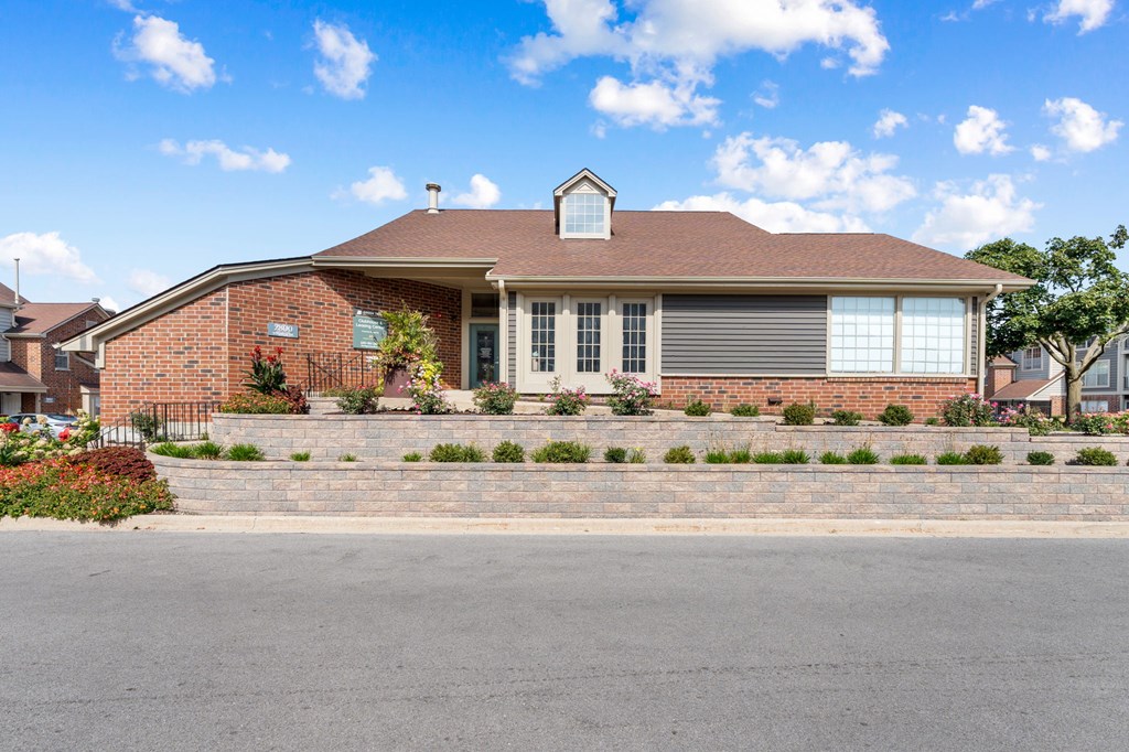 A house with a red brick exterior and a grey roof.