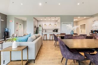 a living and dining room area with a kitchen in the background and a kitchen island in the - Photo Gallery
