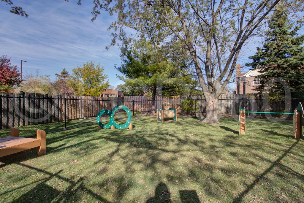 A playground with a swing set and a seesaw.
