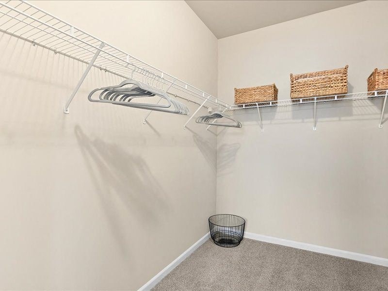 wire shelving and hangers in a large walk-in closet
