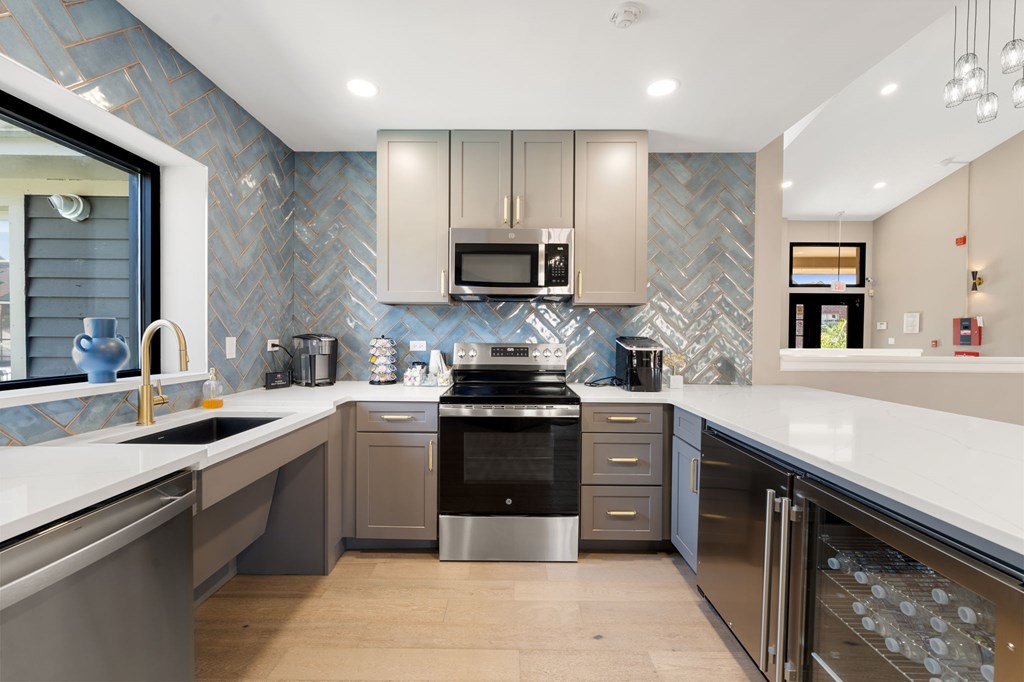 A modern kitchen with a stainless steel dishwasher and oven.
