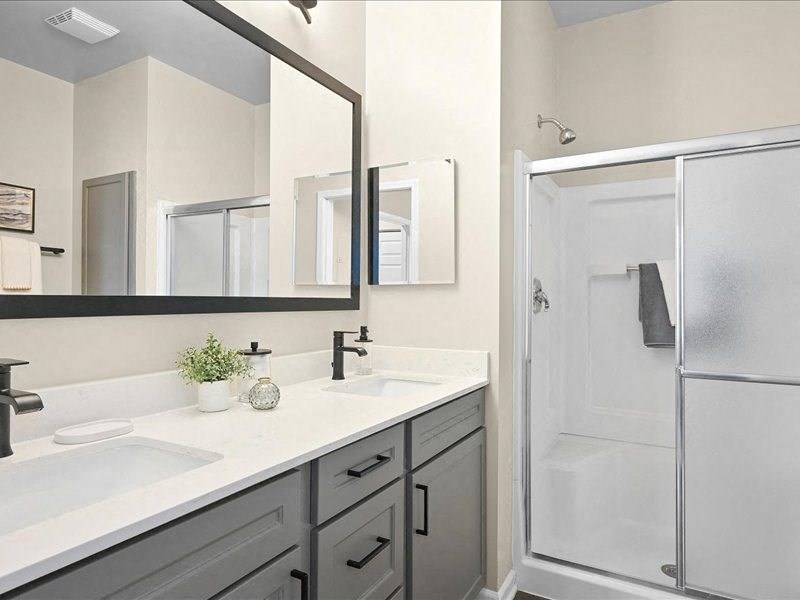 Farmington Lakes renovated bathroom with a standing glass shower and modern fixtures