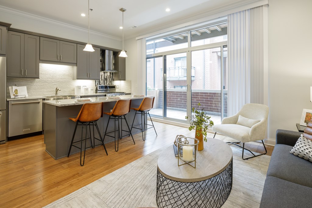 A modern kitchen with a dining area and a living room.